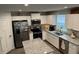 Bright kitchen with white cabinets, stainless steel appliances, and a granite countertop island, perfect for cooking at 200 Mission Terrace Dr, Whiteland, IN 46184