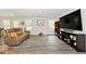Bright living room with large TV, cozy seating, and ample natural light at 200 Mission Terrace Dr, Whiteland, IN 46184