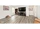 Spacious living room featuring wood-look floors, a large TV, and comfortable furnishings at 200 Mission Terrace Dr, Whiteland, IN 46184