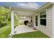 A covered outdoor patio with ample space for seating, complemented by a neat lawn at 200 Mission Terrace Dr, Whiteland, IN 46184