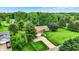 An aerial shot showcasing a charming home with well-manicured lawn surrounded by lush, mature trees at 201 Angela Ct, Noblesville, IN 46062