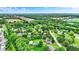 Sprawling aerial view of a neighborhood with lush greenery, tranquil pond, and spacious lots at 201 Angela Ct, Noblesville, IN 46062