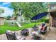 Spacious backyard featuring a patio with stylish furniture, a fire pit, and a custom-built pirate ship play structure at 201 Angela Ct, Noblesville, IN 46062
