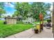 Spacious backyard featuring a patio area, a play structure, lush landscaping, and mature trees at 201 Angela Ct, Noblesville, IN 46062