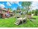 Lush backyard featuring a patio area, a play structure, storage shed, and manicured landscaping at 201 Angela Ct, Noblesville, IN 46062