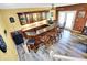 Basement bar with wooden cabinets, granite countertop, bar seating, and access to the outdoors at 201 Angela Ct, Noblesville, IN 46062
