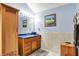 A full bathroom with wooden vanity, a standing cabinet and tiled walls at 201 Angela Ct, Noblesville, IN 46062