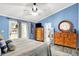 Bright bedroom boasts blue walls, ceiling fan and private balcony access at 201 Angela Ct, Noblesville, IN 46062
