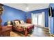 Comfortable bedroom with a ceiling fan, cozy bed, and a view of the outdoors through sliding glass doors at 201 Angela Ct, Noblesville, IN 46062
