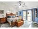 Bright bedroom with a sliding glass door, ceiling fan, and a comfortable queen bed at 201 Angela Ct, Noblesville, IN 46062