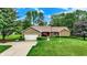 Charming single-story home with brick accents, lush landscaping, and an attached two-car garage at 201 Angela Ct, Noblesville, IN 46062