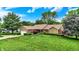 A charming single-story home features a well-manicured lawn and mature trees in a peaceful setting at 201 Angela Ct, Noblesville, IN 46062