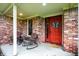 Inviting front porch with brick accents, comfortable rocking chairs, and a decorative butterfly door hanger at 201 Angela Ct, Noblesville, IN 46062