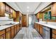 Bright kitchen with wood cabinetry, stainless steel appliances, and updated flooring at 201 Angela Ct, Noblesville, IN 46062