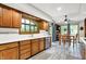 Charming kitchen with wood cabinets, a garden window, and a dining area at 201 Angela Ct, Noblesville, IN 46062