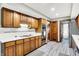 Spacious kitchen featuring wood cabinets, stainless appliances, and modern tile floors at 201 Angela Ct, Noblesville, IN 46062