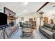 Spacious living room featuring a brick fireplace, plush sofas, and stylish decor at 201 Angela Ct, Noblesville, IN 46062