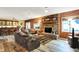 Spacious living room with a brick fireplace, comfortable sofas, and a view into the basement bar at 201 Angela Ct, Noblesville, IN 46062