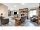 Cozy living room with a brick fireplace, comfortable seating, and plenty of natural light at 201 Angela Ct, Noblesville, IN 46062