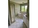 Bathroom featuring a bathtub with window and a standing shower at 213 Golf Ct, Greenwood, IN 46143