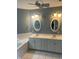 Bathroom with double vanity, sinks, tub, and matching oval mirrors at 213 Golf Ct, Greenwood, IN 46143