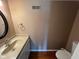 Bathroom featuring granite countertops, white cabinets and wood flooring at 213 Golf Ct, Greenwood, IN 46143