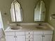Bathroom featuring double sinks, decorative mirrors and olive green walls at 213 Golf Ct, Greenwood, IN 46143
