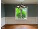 Dining area with hardwood floors, decorative wall trim, and a bright window with leafy green view at 213 Golf Ct, Greenwood, IN 46143