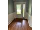 Inviting entryway with hardwood floors, decorative wall trim, and a glass-paneled front door at 213 Golf Ct, Greenwood, IN 46143