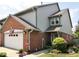 Charming home exterior featuring a brick facade, attached garage, and manicured landscaping at 213 Golf Ct, Greenwood, IN 46143