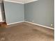 Living room with neutral carpet, trim, and blue walls at 213 Golf Ct, Greenwood, IN 46143