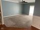 Living room with neutral carpet, trim, and blue walls at 213 Golf Ct, Greenwood, IN 46143