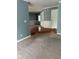 Carpeted living room with view towards dining room and front entry, with ample natural light at 213 Golf Ct, Greenwood, IN 46143