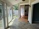 Sun room with tiled floor and glass doors that lead to the kitchen and a rear patio at 213 Golf Ct, Greenwood, IN 46143