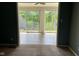 View from living room to bright sun room with tiled floors and sliding glass doors to the backyard at 213 Golf Ct, Greenwood, IN 46143