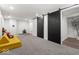 Spacious finished basement with carpeted floors and modern sliding barn doors at 2521 Mcleay Dr, Indianapolis, IN 46220