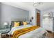 Bedroom with a tufted headboard, a round mirror, and views to the hallway at 2521 Mcleay Dr, Indianapolis, IN 46220