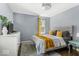 A cozy bedroom with a tufted headboard, colorful accents, and natural light at 2521 Mcleay Dr, Indianapolis, IN 46220