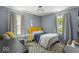 A well-lit bedroom with modern accents and lots of natural light at 2521 Mcleay Dr, Indianapolis, IN 46220