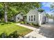 Charming home exterior features lush landscaping, mature trees, and a well-maintained lawn at 2521 Mcleay Dr, Indianapolis, IN 46220