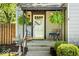 Charming front porch with hanging plants, seating, and classic architectural details at 2521 Mcleay Dr, Indianapolis, IN 46220