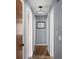 A well-lit hallway with hardwood floors and neutral paint at 2521 Mcleay Dr, Indianapolis, IN 46220
