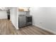 Modern laundry room featuring new washer and dryer units, ample storage, and laminate flooring at 2521 Mcleay Dr, Indianapolis, IN 46220