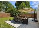 A charming backyard patio features bluestone pavers, an outdoor dining set, and a large sun umbrella at 2521 Mcleay Dr, Indianapolis, IN 46220