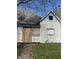 An exterior view of a distressed single-Gathering home with boarded-up windows needing full rehab at 330 N Lasalle St, Indianapolis, IN 46201