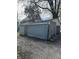 View of a detached garage needing repair and a gravel driveway, potentially for renovation at 330 N Lasalle St, Indianapolis, IN 46201