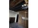 Interior showing exposed wall studs, open ceilings, and room needing remodeling and repair at 330 N Lasalle St, Indianapolis, IN 46201