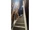 An interior stairway requiring renovation, showing structural components and damage at 330 N Lasalle St, Indianapolis, IN 46201