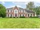 Charming brick home featuring a landscaped front yard, white shutters, and a statement purple front door at 3772 Christina Ct, Carmel, IN 46033