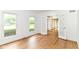 Bright living room with wood floors, large windows, and French doors leading to additional living spaces at 3772 Christina Ct, Carmel, IN 46033